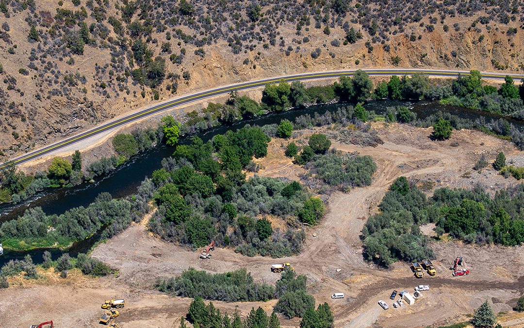Overhead view of river bend showing reconstruction work with heavy equipment