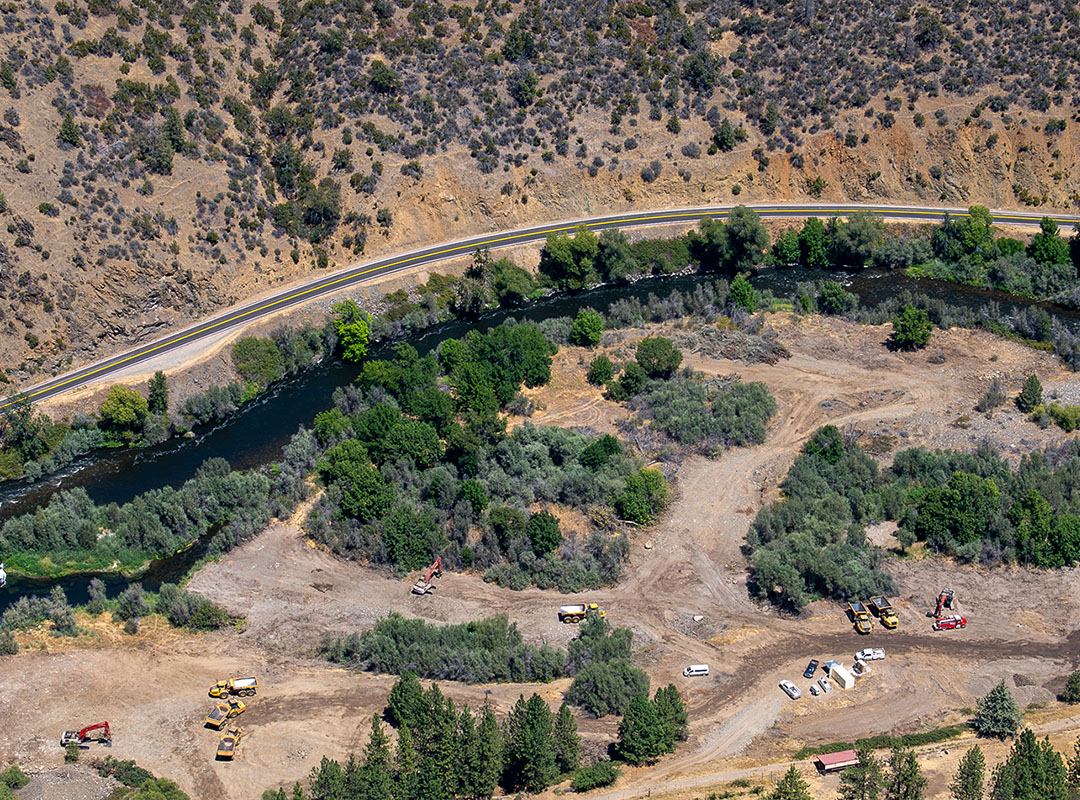 Overhead view of river bend showing reconstruction work with heavy equipment
